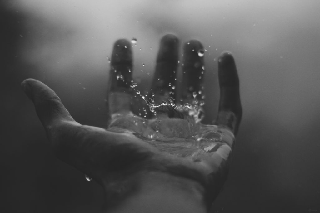 on writing: water unsplash image hand
