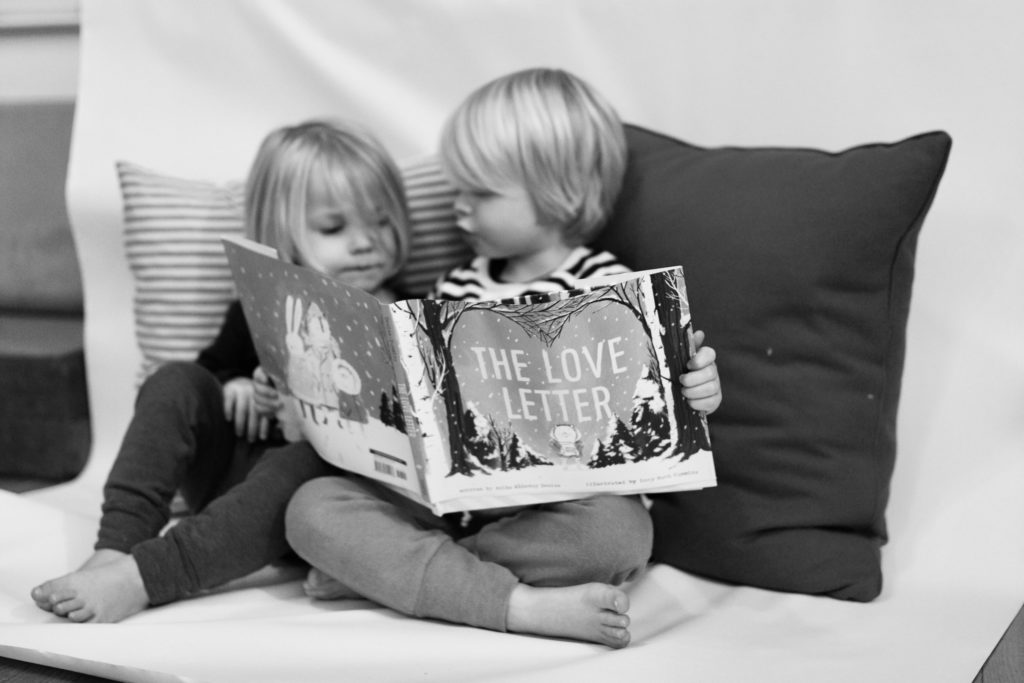 5 Favorite Valentine's Books for Tiny Book Lovers blog post | www.yourstrulyelizab.com | photo of two boys with book by Eliza B.