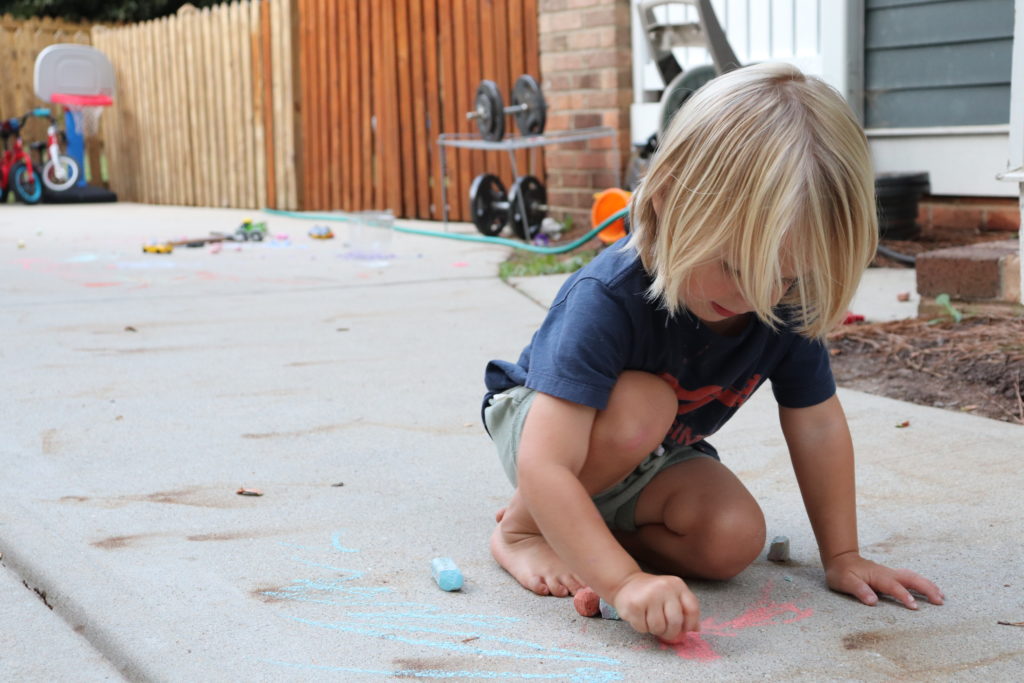 Monthly Intentions blog post | www.yourstrulyelizab.com | boy drawing with chalk photo by Eliza B.