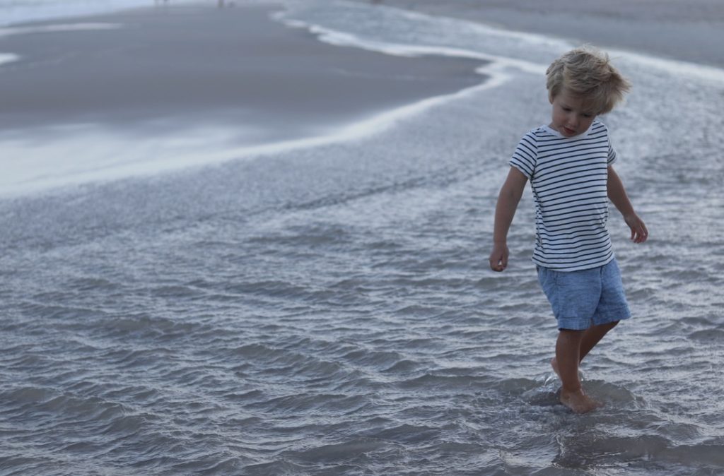 September Intentions blog post | www.yourstrulyelizab.com | boy walking in the surf on a beach - photo by Eliza B.